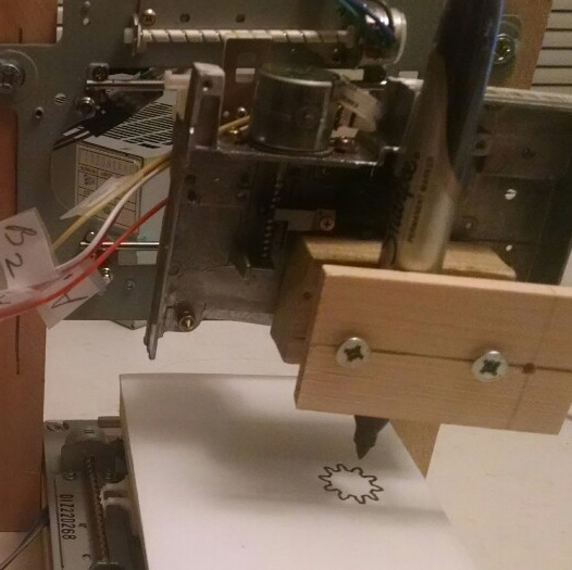 A homemade cnc made from old parts drawing a gear with a sharpie