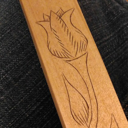 Flower etched on a board